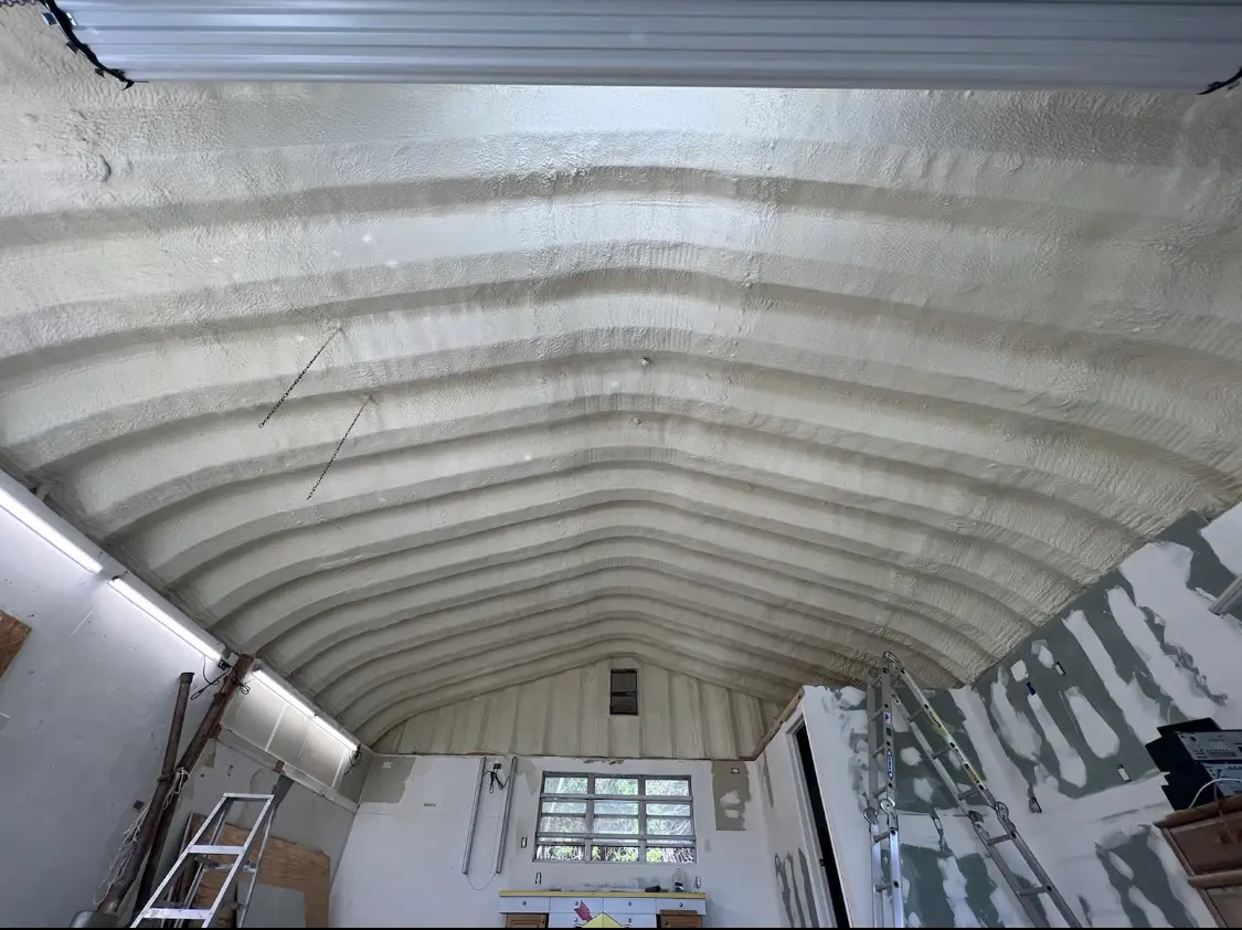 Spray polyurethane foam applied to the underside of a metal roof deck in Winston